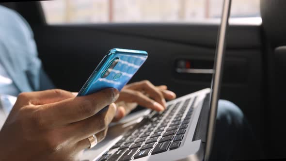 African American Businessman Rides in Car with Laptop