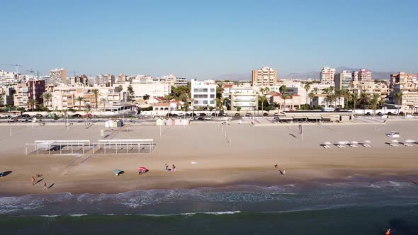 Aerial sideways view of Playa de Muchavista, an urban sandy beach in El Campello, Spain. Mediterrane