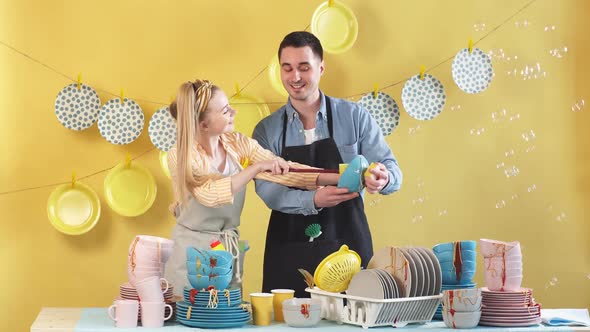 Attractive Young Couple Dusting the Plates. Hobby, Daily Routine