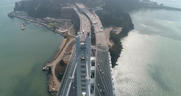 Aerial shot of vehicles moving on San Francisco–Oakland Bay Bridge with city in background