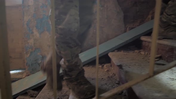 Soldiers Climbing Stairs of Ruined Building