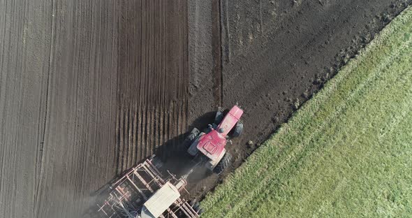 Countryside and Agriculture, Farm Tractors Plow the Earth in Field, Dust in the Field, View From