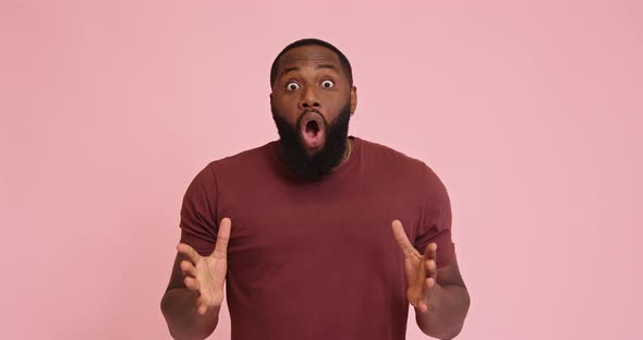 Young African American Man Surprised Isolated on Pink Background