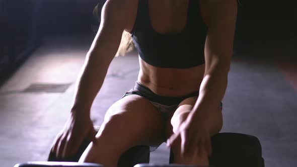 Female Athlete Does Curl Ups on Gym Mat