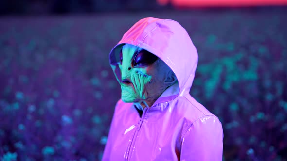 Portrait of Spooky Alien in Field Under Colorful Neon Light