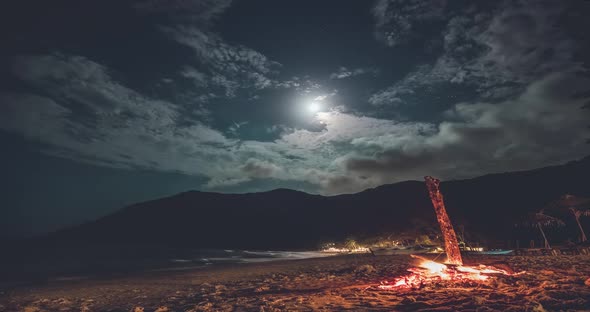 Thailand Beach Night Timelapse Fire at Sand Ocean Shore with Mountain Silhouette at Moon Stars Sky alt