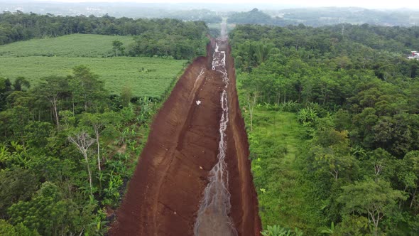 Land clearing for the highway from aerial drone footage of forward motion