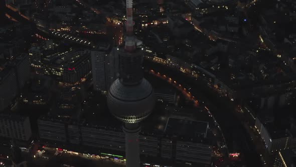 AERIAL: Over Berlin Germany TV Tower Alexanderplatz at Night with City Lights Traffic 