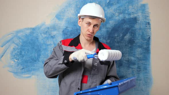 Engaged Worker in Jumpsuit Films Painting Process for Blog