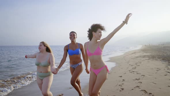 young women having fun on the beach