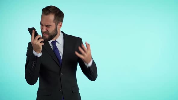 Businessman screaming on mobile phone. Having nervous breakdown at work, shouting in anger