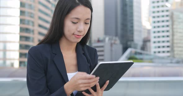 Business woman using digital tablet in the evening 