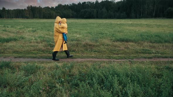 Father Walks in the Park in the Evening with a Small Child