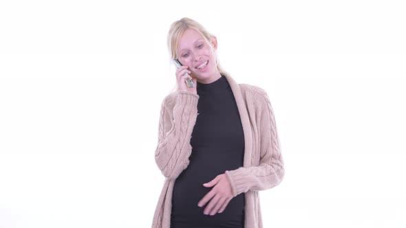 Happy Young Blonde Pregnant Woman Talking on the Phone