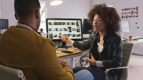 Two colleagues discussing in creative office