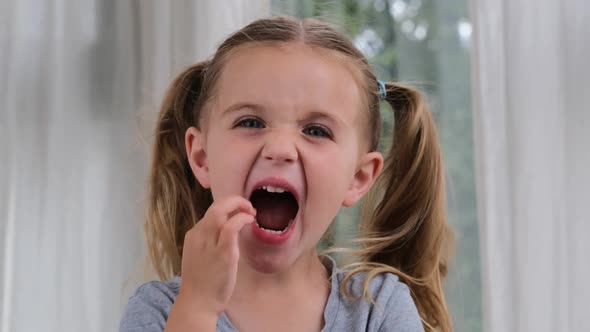 Funny Preschooler Girl Points to Lost Tooth with Finger