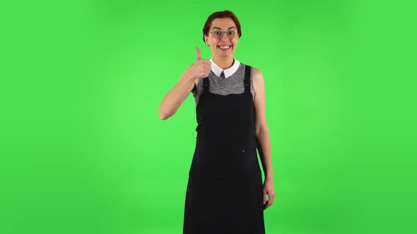 Funny Girl in Round Glasses Is Showing Thumbs Up, Gesture Like. Green Screen