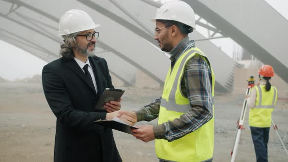 Investor Using Tablet Then Meeting Engineer Shaking Hands Discussing Construction Project