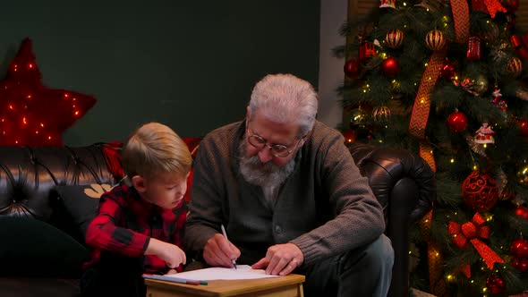 Grandfather Teaches His Grandson To Draw with Felttip Pens