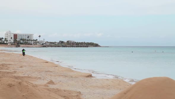 Rider Rides a Motorcycle on the Beach