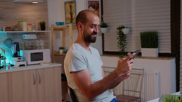 Man Using Phone and Smile While Working