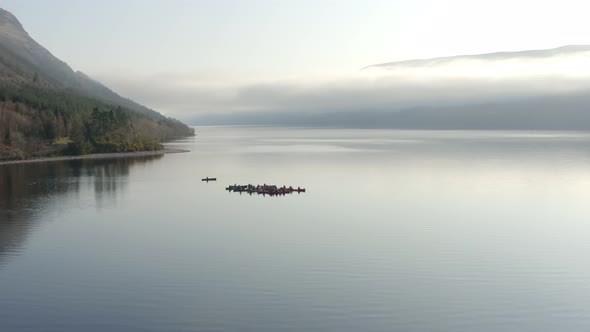 A Team of Canoeists on a Lake in the Early Morning