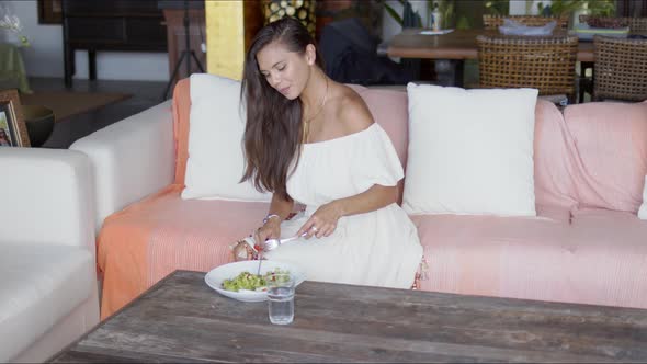 Young Woman Having Lunch in Hotel Lounge