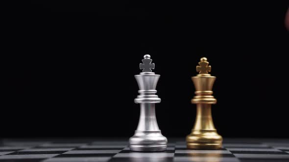 Close up of male hand moving gold king chess for defeating opponent, Game of Chess. Leader and Teamw