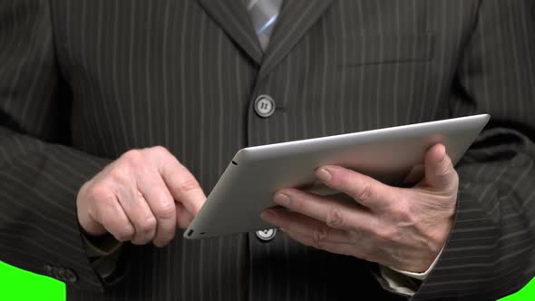 Man in Suit Scrolling Tablet, Close Up.
