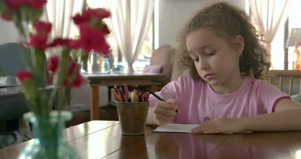 Happy Little Girl or Cute Primary Child School Child of 78 Years Old at Home Relaxing Sits in House