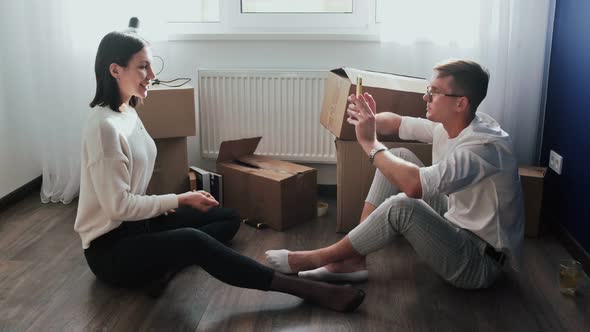 Happy Couple Relaxes After Moving in a New Home