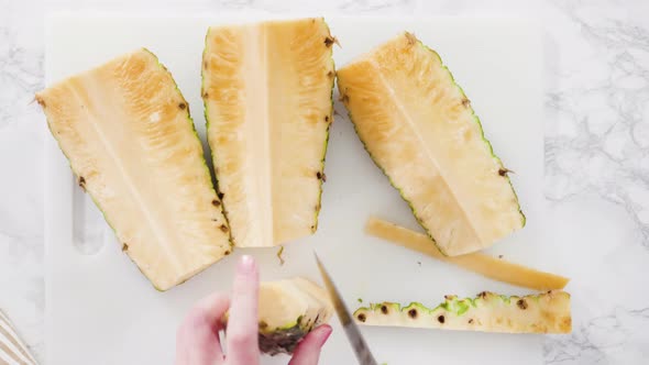 Flat lay. Cleaning and cutting a pineapple into the small pieces.