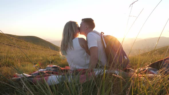 Couple in love sitting on a picnic blanket