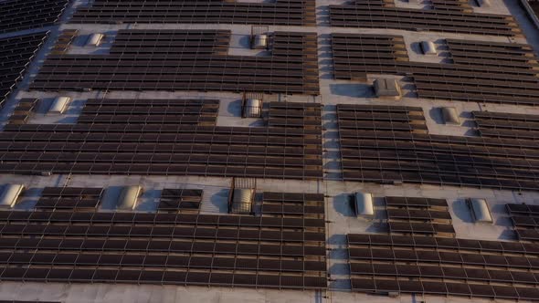 Aerial shot of solar panels covers the roof of a large building