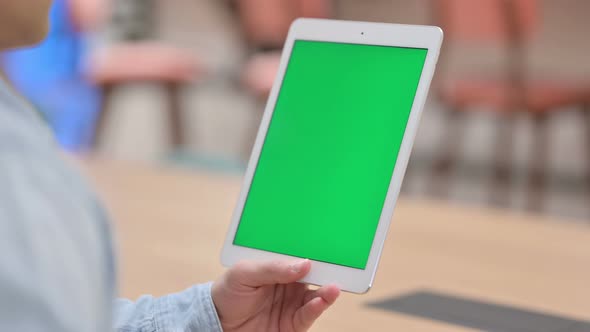 Man Using Tablet with Green Chroma Key Screen