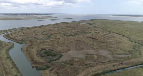 Aerial pull back shot over Tollesbury marshes