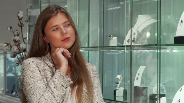 Attractive Young Businesswoman Shopping for Jewelry at the Store