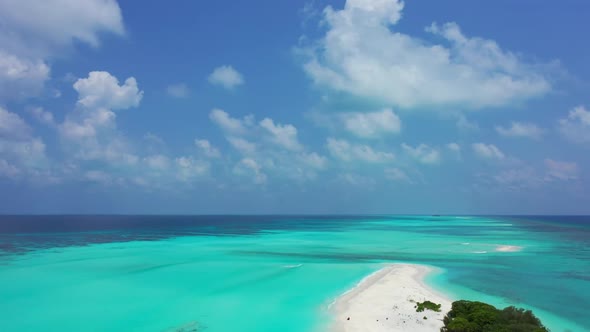 Aerial flying over sky of tropical coastline beach lifestyle by blue green sea and white sandy backg