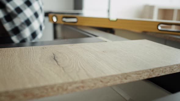 Video of carpenter designing cut lines for boards. Shot with RED helium camera in 8K