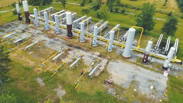 Aerial View Gas Production. Large Gas Distribution Complex. A Gas Worker or a Station Operator Shuts