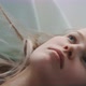 Close up of young blonde woman laying on her back daydreaming - VideoHive Item for Sale