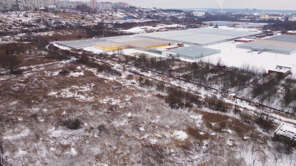 Greenhouse Complex on the Outskirts of the City in Winter Top View