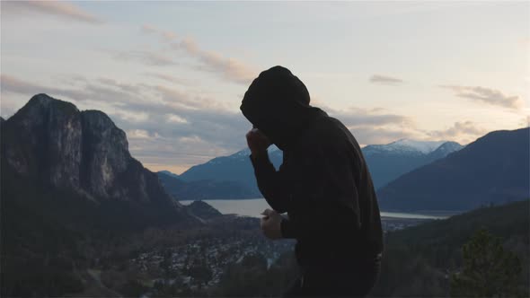 Caucasian Man Wearing a Black Hoodie Practicing Shadow Boxing