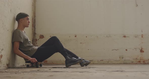 Fashionable young man in an abandoned warehouse