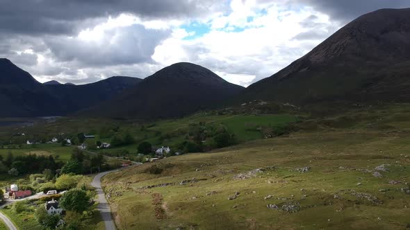 Panning shot of scottish mountain village. Aerial video shot by a drone. Scotland