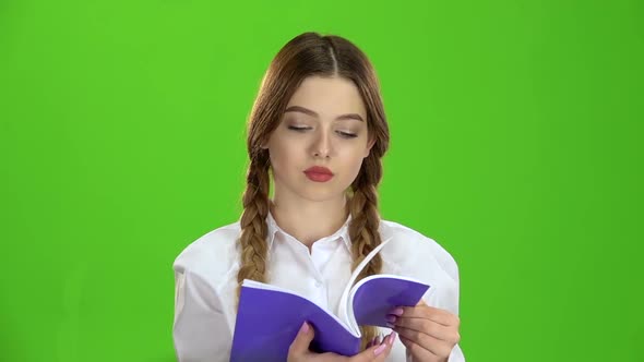 Student Looks at the Notebook and Learns the Material. Green Screen. Slow Motion