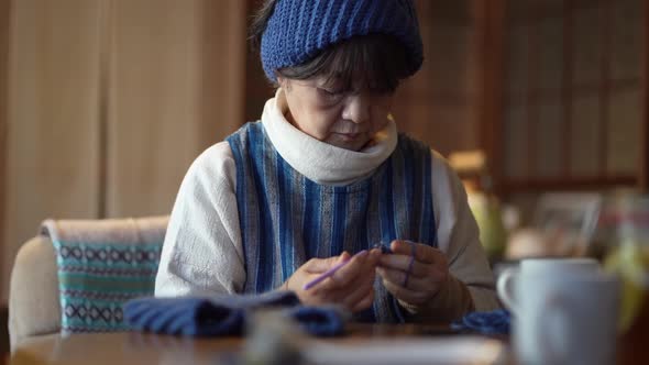A woman knitting a neck warmer