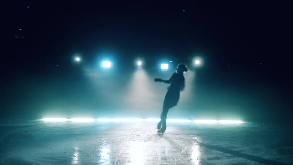 Female Skater is Doing a Jumping Element on the Rink