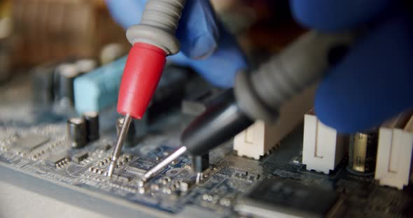 Repairman in Electronics Repair Service By Means of the Tester Checks Serviceability of the Device