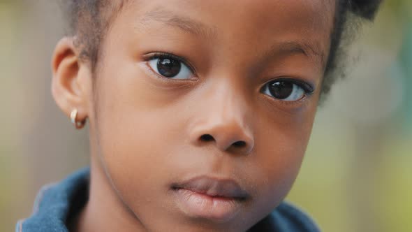 Closeup Unemotional Child Face African American Little Girl Pensive Looking at Camera Sad Lonely No